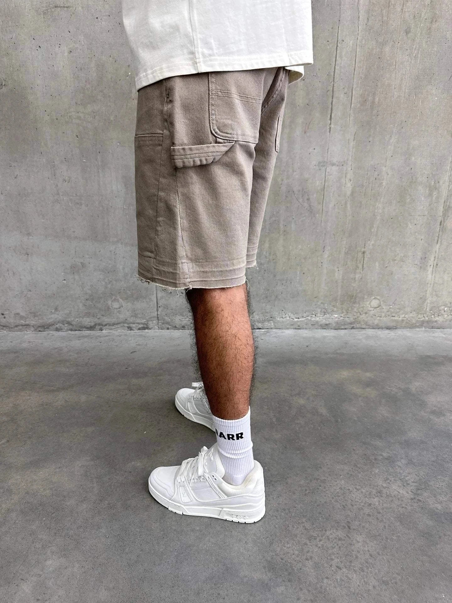 Siarr Rio Shorts Beige with raw hem and belt loops.