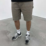 Siarr Rio Shorts Sage with raw hem and branded detailing.