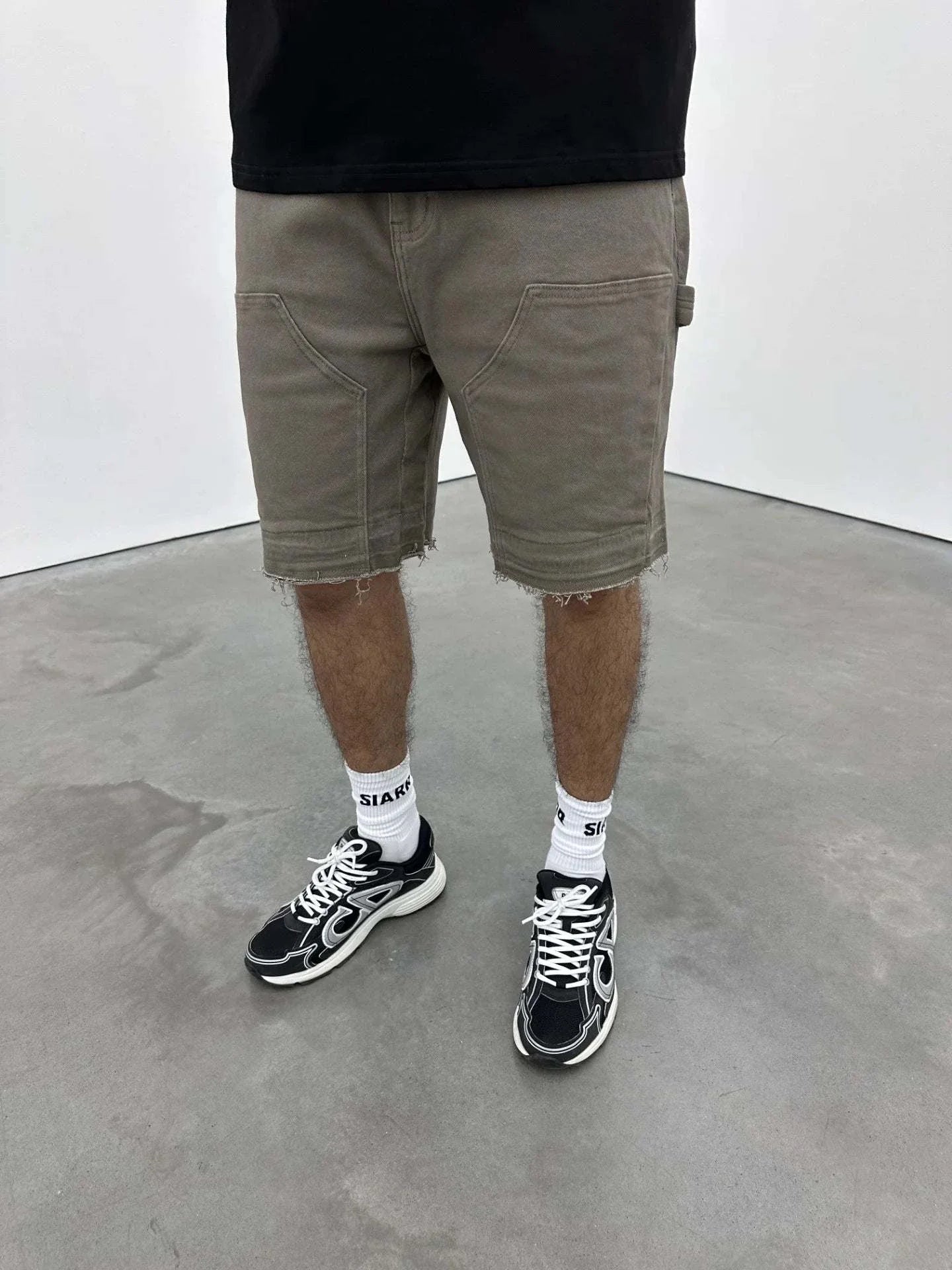 Siarr Rio Shorts Sage with raw hem and branded detailing.