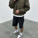 Siarr Venetian Windbreaker khaki nylon jacket with relaxed fit and side slit pockets worn with black shorts and white sneakers