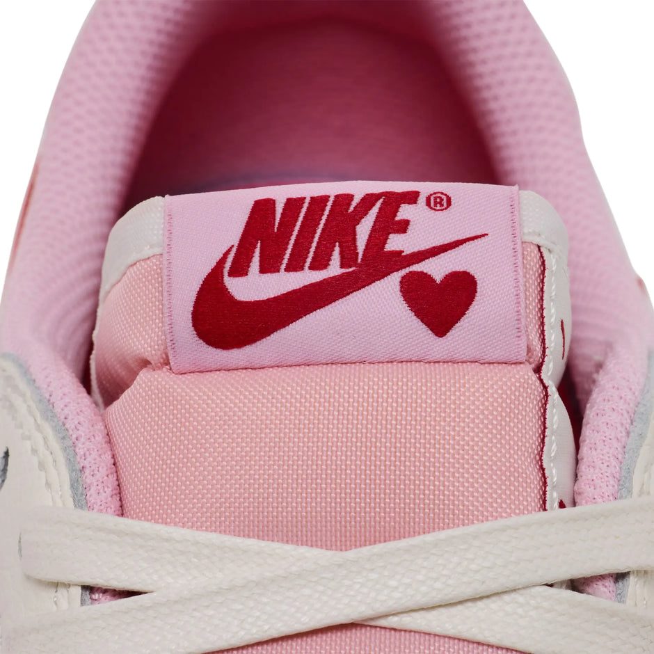 Travis Scott x Air Jordan 1 Retro Low OG Sail Tropical Pink sneakers with reverse Swoosh and vibrant pink accents