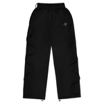 Black Saint Mind Wavy baggy sweatpants with metallic logo, side pockets, ribbed waistband, and adjustable ankle toggles