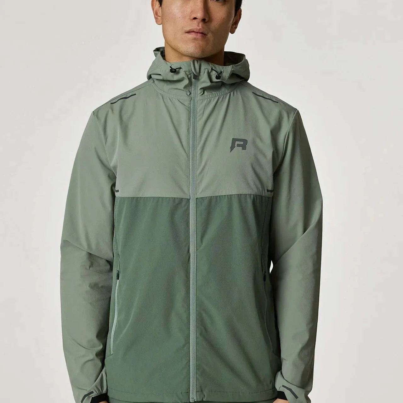 Reprimo Xcelerate Windbreaker in sage and botanical colors worn by a model.