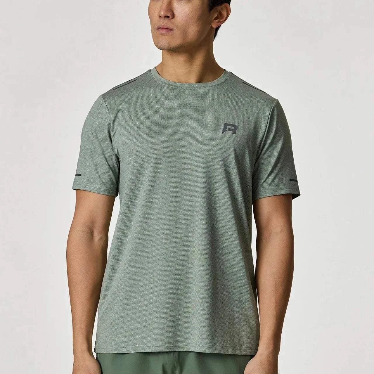 Reprimo Xcelerate T-Shirt in Sage color worn by a model.